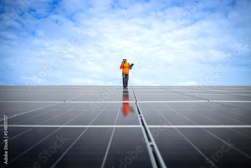 Renewable energy sources and solar engineer checking photovoltaic panels and electricity production.