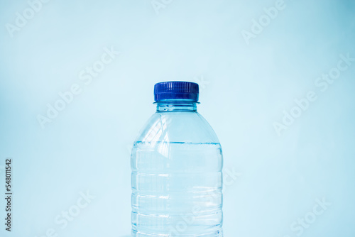 Plastic water bottle on blue background photo