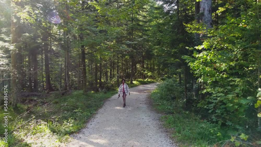 Slow motion video of a black woman with backpack enjoying while hiking alone through the forest. Slow motion video of a black woman with backpack enjoying while hiking alone through the forest.