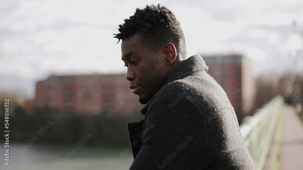Pensive black man thinking about life on top of city bridge. Elegant African person close-up contemplative face Pensive black man thinking about life on top of city bridge. Elegant African person close-up contemplative face