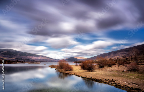 Fast clouds over Pinilla del Valle reservoir, in Madrid province. photo