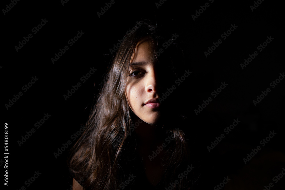 Portrait of a teen girl in low key light Portrait of a teen girl in low key light