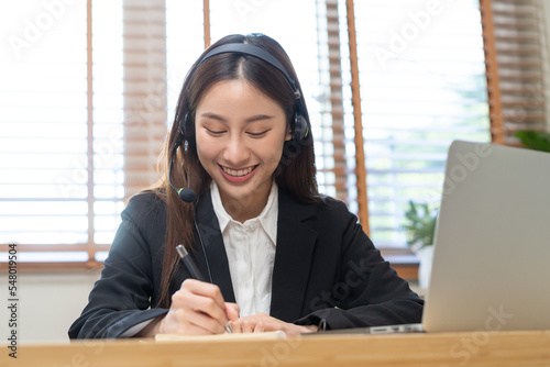 Operator, smile asian young woman wearing headset, headphones and speaking on video call conference with customer, colleagues support phone, work on laptop computer.Technology of help, consult service