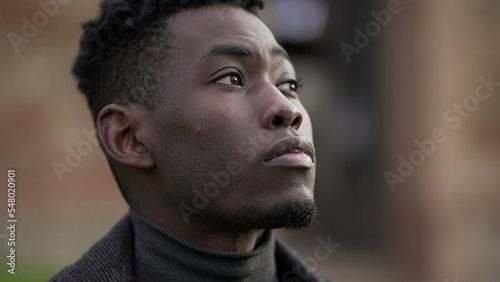 Pensive black African man looking at sky looking for hope