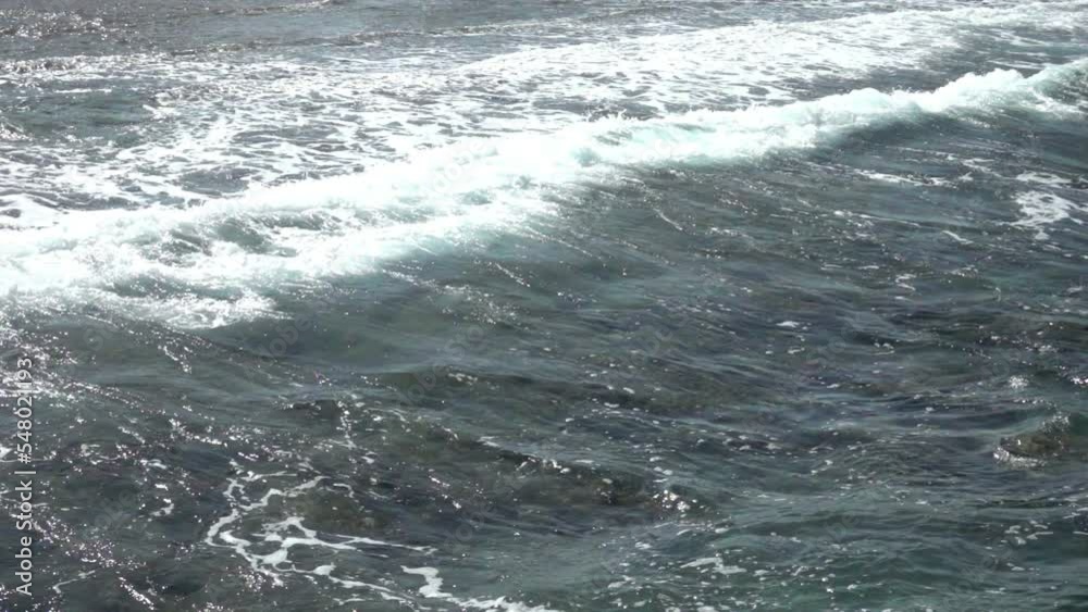 Transparent blue-green sea and waves on rocky corals. Slow motion Transparent blue-green sea and waves on rocky corals. Slow motion