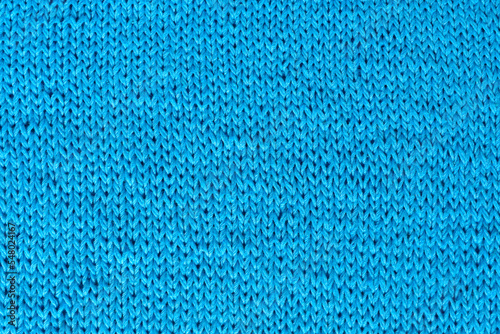 Knitted fabrics. Background from blue jersey. Knitted fabric.