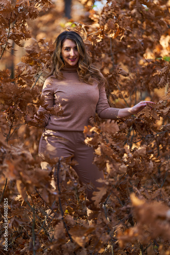 Size plus woman in a forest in the autumn