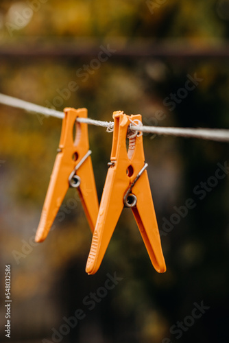 Multi-colored clothespins on a clothesline. Wet clothespins close-up