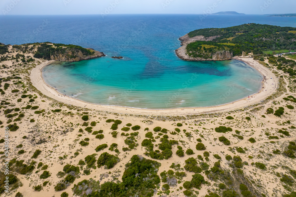 Aerial drone photo of the iconic  semicircular sandy beach of Voidokoilia in Messinia, Gialova, Peloponnese, Greece