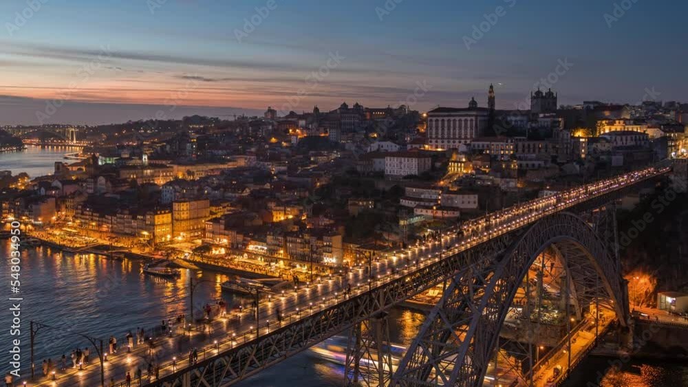 Dusk to night timelapse view of Porto cityscape and Dom Luis I Bridge over the Douro River in Porto (Oporto), Portugal, zoom out.
Dusk to night timelapse view of Porto cityscape and Dom Luis I Bridge over the Douro River in Porto (Oporto), Portugal, zoom out.
