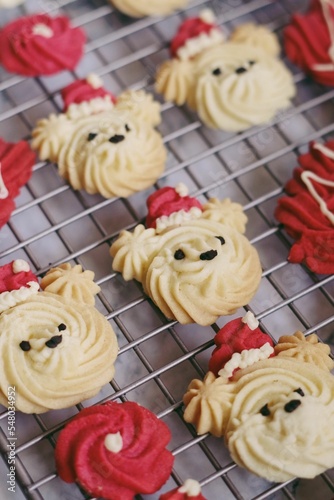 Vertical closeup shot of bear cookies with Santa Claus hats on the metal net