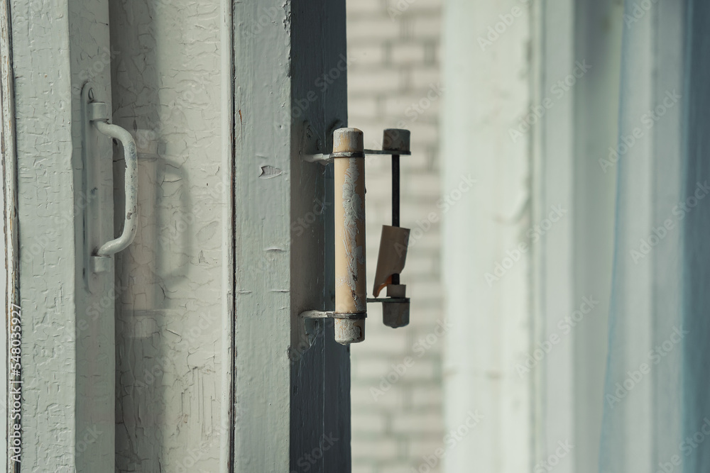 Old wooden window frame with broken handle close side view. Retro rustic window closeup. Old wooden window frame with broken handle close side view. Retro rustic window closeup.