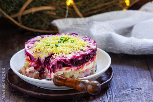 Obraz na płótnie Dressed herring, raditional Soviet festive salad of herring and vegetables in a New Year's decoration. w salonie