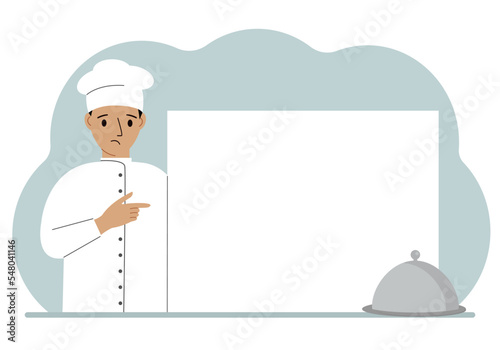 A male cook in uniform and a cap holds a large sheet of paper. Concept for menu, recipe book, blank cookbook or records.
