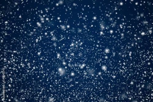 Obraz na plátně Winter holidays and wintertime background, white snow falling on dark blue backd