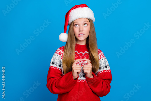 Photo of pretty lovely teenager fingers touch interested look up empty space advert dream noel present isolated on blue color background © deagreez