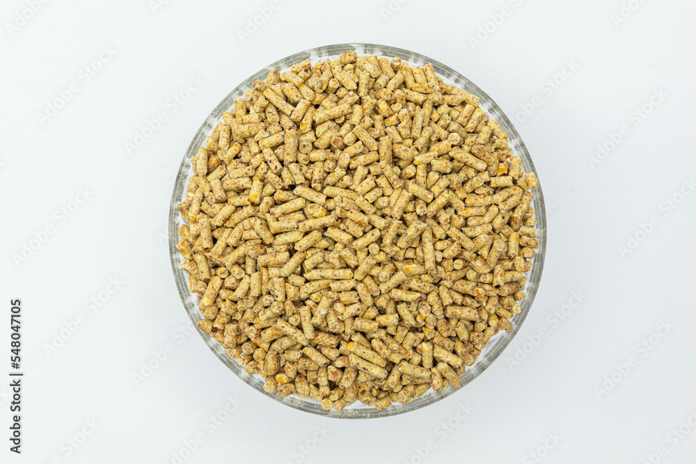 Fraction of feed additives for animals on a white background in a bowl Fraction of feed additives for animals on a white background in a bowl