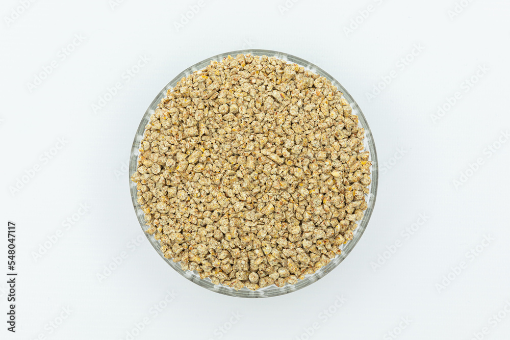 Fraction of feed additives for animals on a white background in a bowl Fraction of feed additives for animals on a white background in a bowl