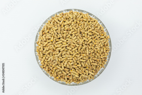 Fraction of feed additives for animals on a white background in a bowl