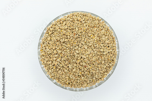 Fraction of feed additives for animals on a white background in a bowl