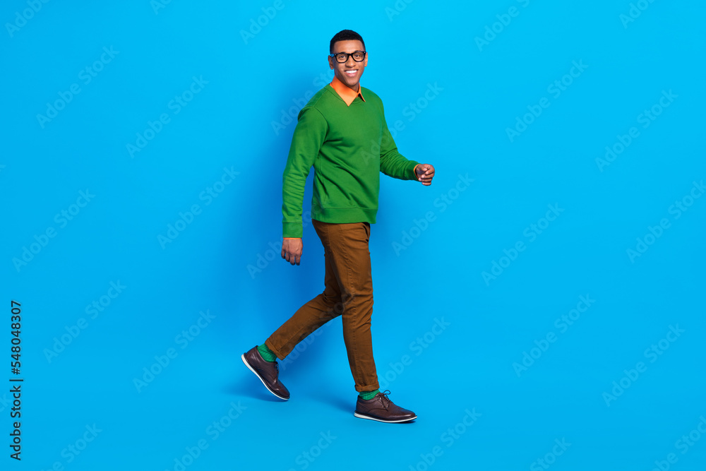 Full size profile photo of young satisfied positive guy wear nice shoes classy gentleman outfit walking his office isolated on bright blue color background