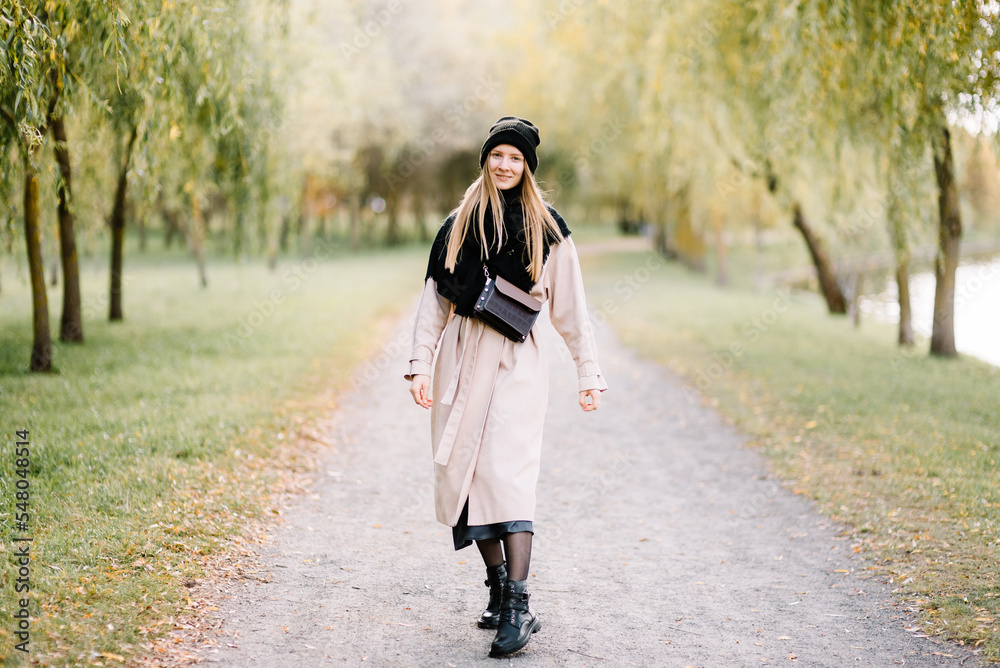 young beautiful girl is resting in nature. woman walking in the park on sunny autumn day young beautiful girl is resting in nature. woman walking in the park on sunny autumn day