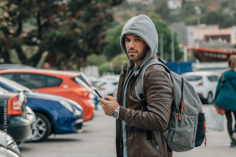 man with backpack and mobile phone traveling or tourism in autumn or winter man with backpack and mobile phone traveling or tourism in autumn or winter