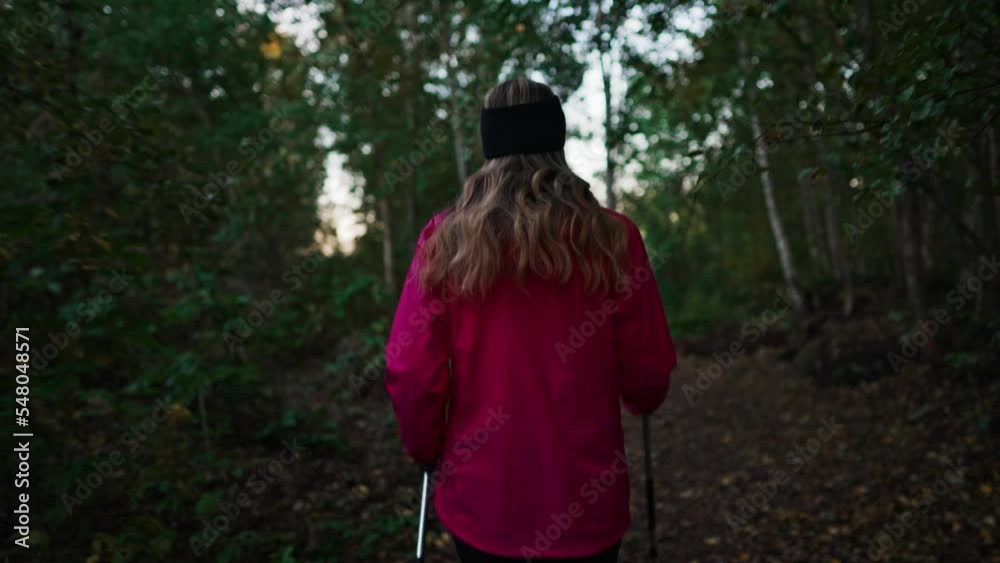 Woman with trekking sticks. Nordic walking. Woman with trekking sticks. Nordic walking.