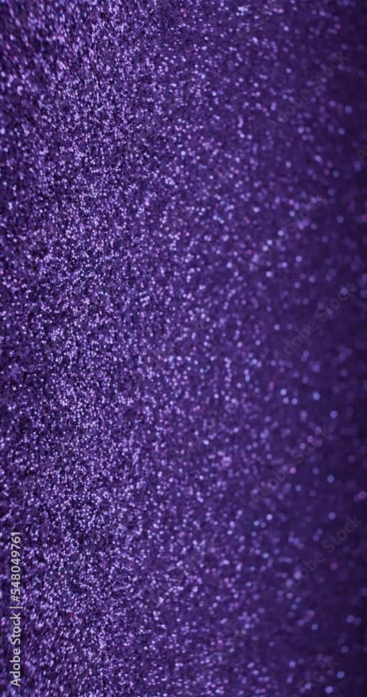 Vertical video. Glitter abstract background. Blur sparkles texture. Defocused neon pink blue purple golden color shimmering flicker glow. Shot on RED Cinema Camera.