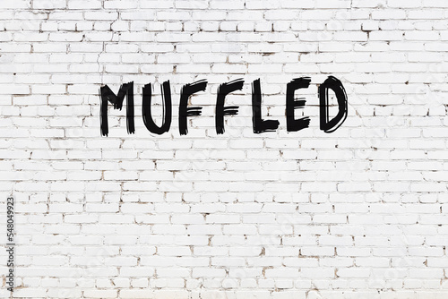 White wall with black paint inscription muffled on it