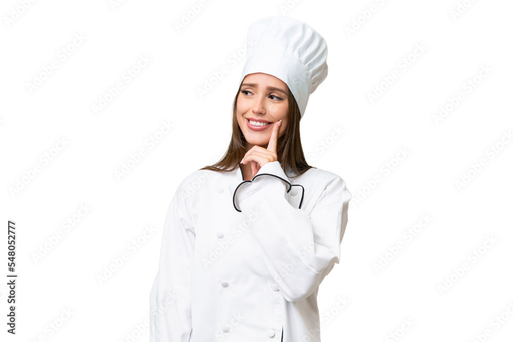 Young chef caucasian woman over isolated background thinking an idea while looking up
