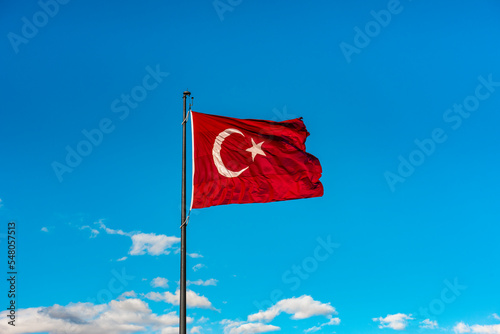 Turkish Flag waving in blue sky.