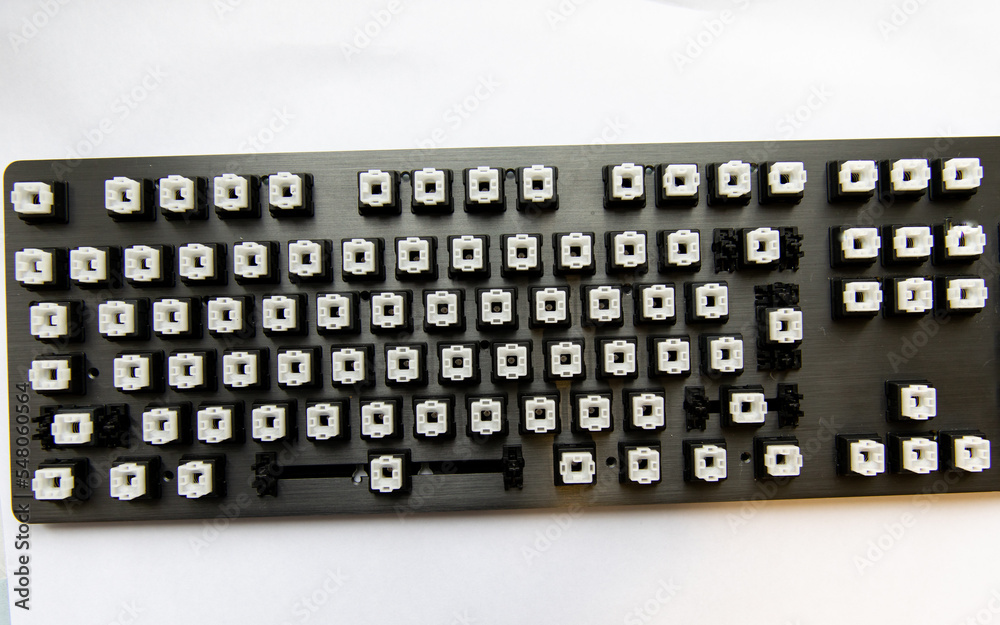 Disassembled black computer keyboard without buttons. Disassembled black computer keyboard without buttons.