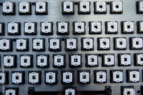 Disassembled black computer keyboard without buttons.