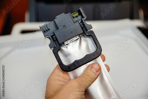 Installing an ink container in an inkjet printer. photo
