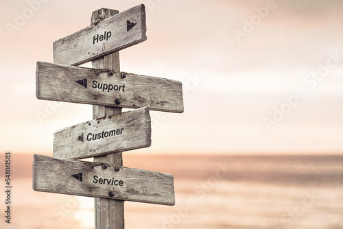 help support customer service text written on wooden signpost outdoors at the beach during sunset