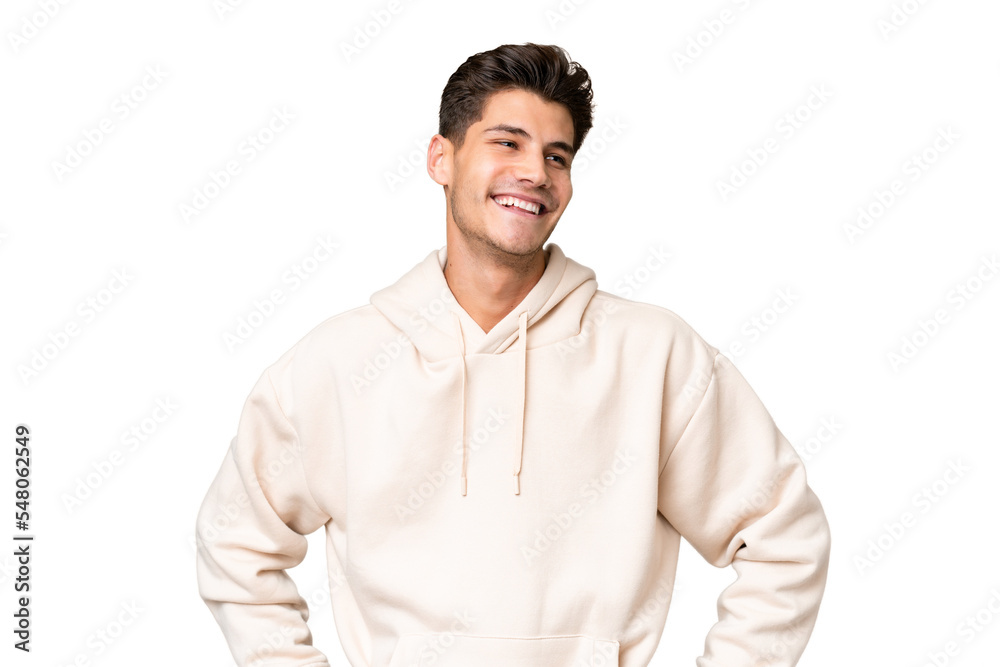 Young caucasian handsome man over isolated background posing with arms at hip and smiling Young caucasian handsome man over isolated background posing with arms at hip and smiling