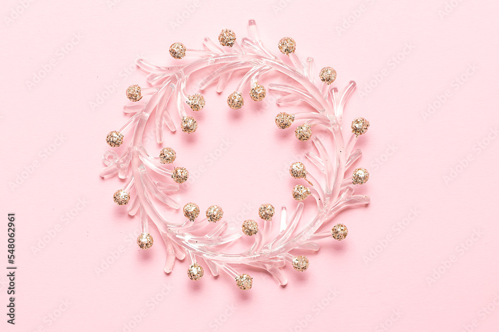 Shining Christmas wreath on light pink background with copy space for your design.