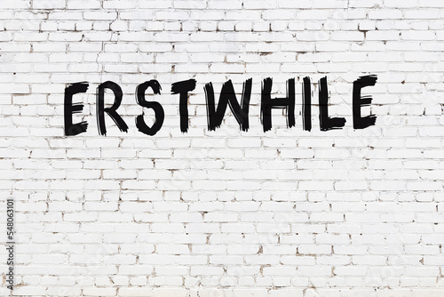 Inscription erstwhile painted on white brick wall