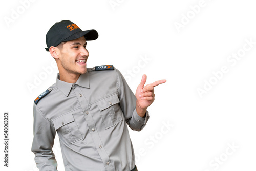 Young security man over isolated background pointing finger to the side and presenting a product