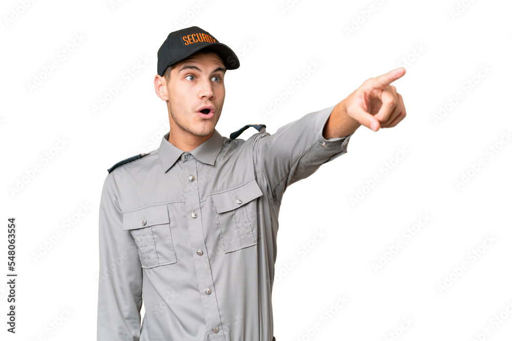 Young security man over isolated background pointing away Young security man over isolated background pointing away