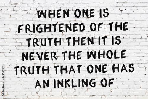 Black painted inscription of smart quote on white brick wall