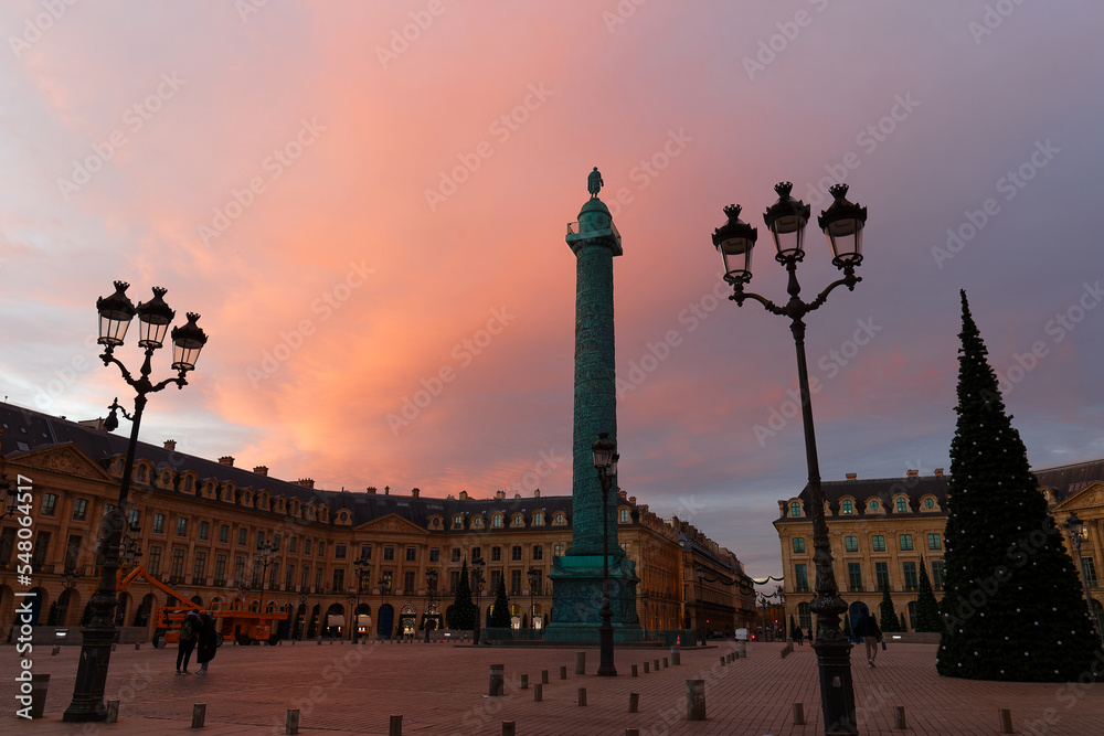 Vendome column with statue of Napoleon Bonaparte, on the Place Vendome decorated for Christmas at sunrise , Paris, France.