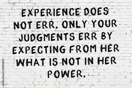 Black painted inscription of smart quote on white brick wall