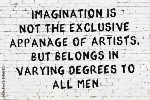 White brick wall with painted black inscription of wise quote photo
