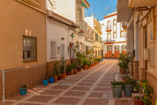 Cozy small street with planters and flower pots in the La Carihuela district in the city of Torremolinos in Spain. photo