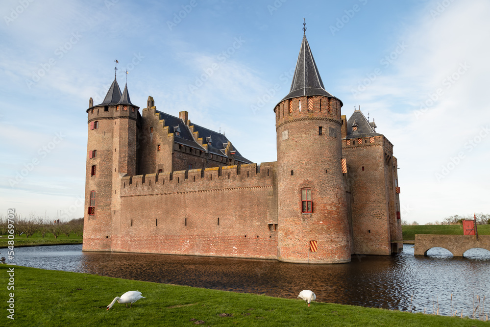 Medieval Dutch castle - Muiderslot, built in the year 1285, with the castle moat in the foreground.