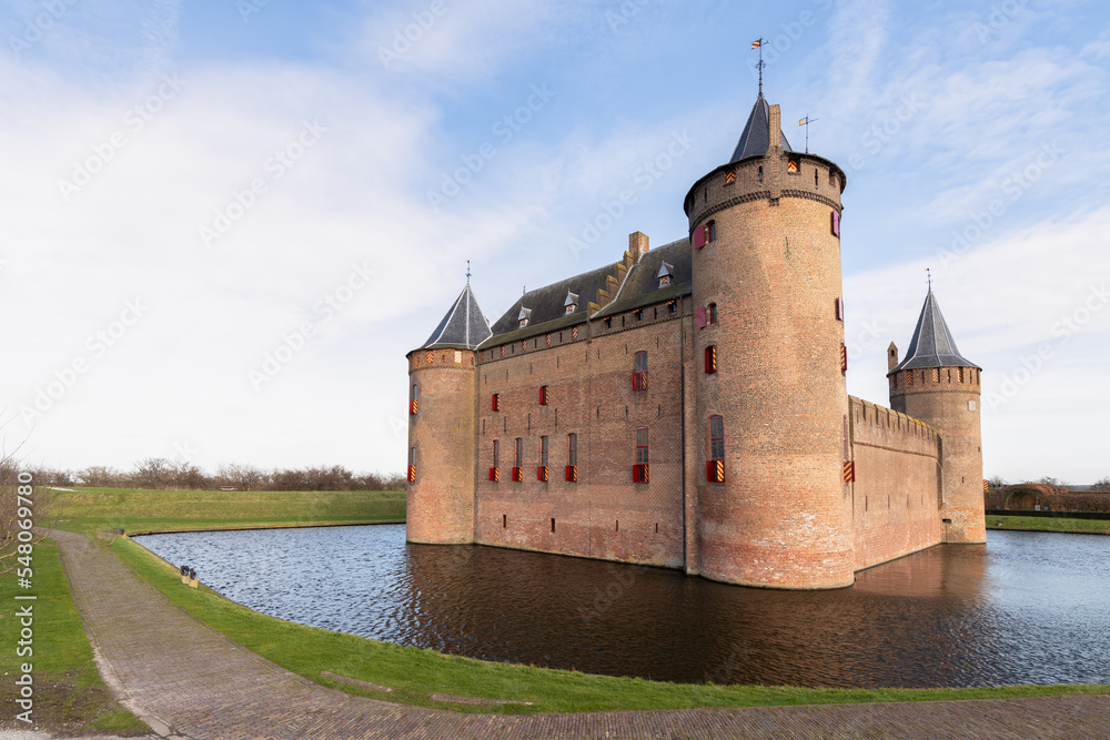 Medieval Dutch castle - Muiderslot, built in the year 1285, with the castle moat in the foreground.