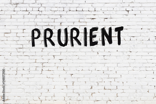 Inscription prurient painted on white brick wall photo