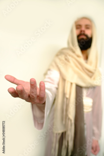 biblical scene, Jesus Christ Hand ask for follow or following as offer or offering, young pensive bearded and mustachioed man, guy with 30 years in image of Savior, concept of Holy Scriptures